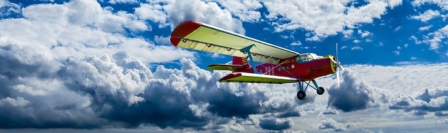 A colorful airplane flying in the sky Description automatically generated with low confidence