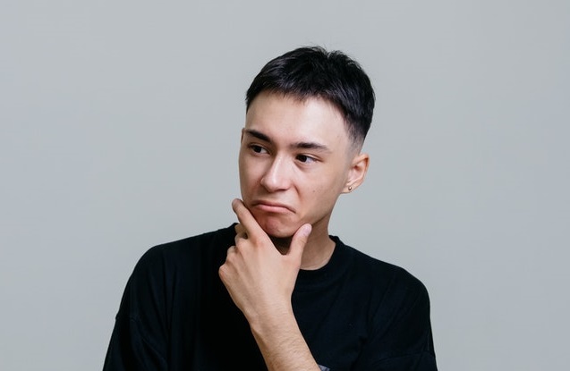 A person with his hand on his chinDescription automatically generated with medium confidence